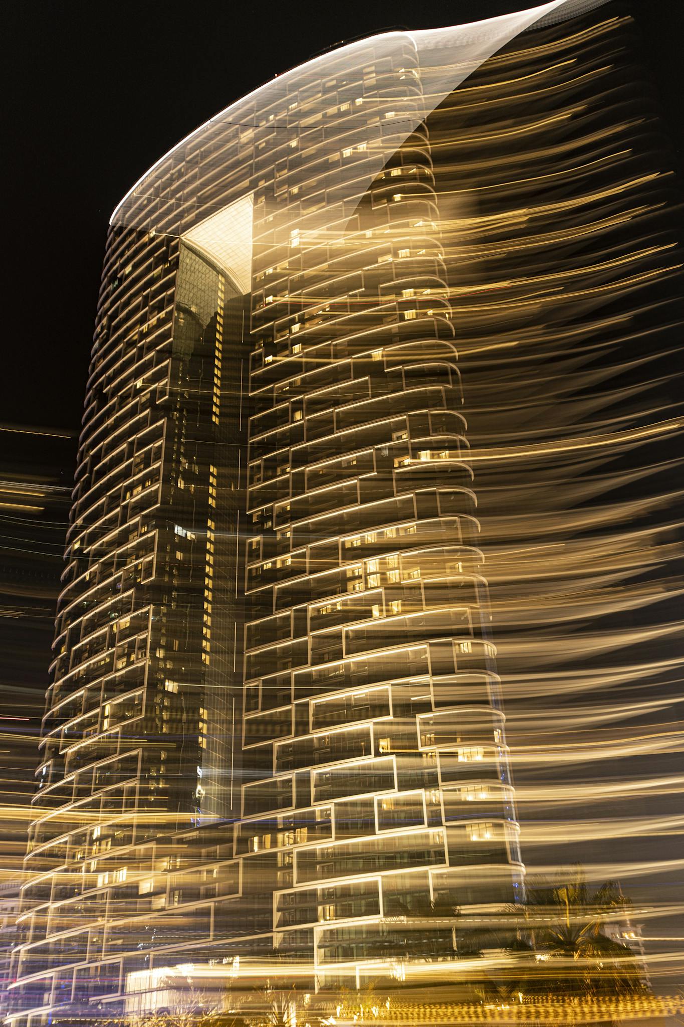 Captivating long exposure night shot of a hotel in Dubai with golden lights.
